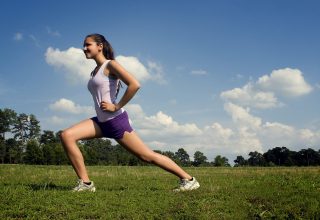 young-woman-stretching-outdoors-before-exercising