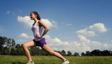 young-woman-stretching-outdoors-before-exercising
