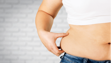 a woman's stomach is shown with her hands on her hips.