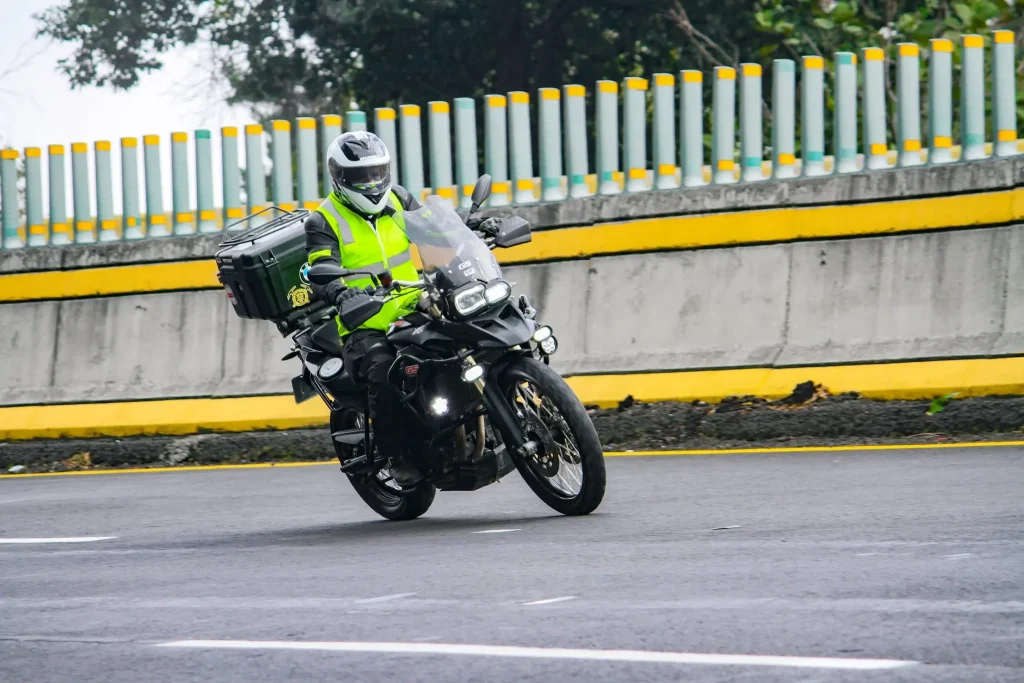 a man riding a motorcycle down a curvy road.