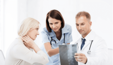 a group of spine surgeons looking at a x - ray.