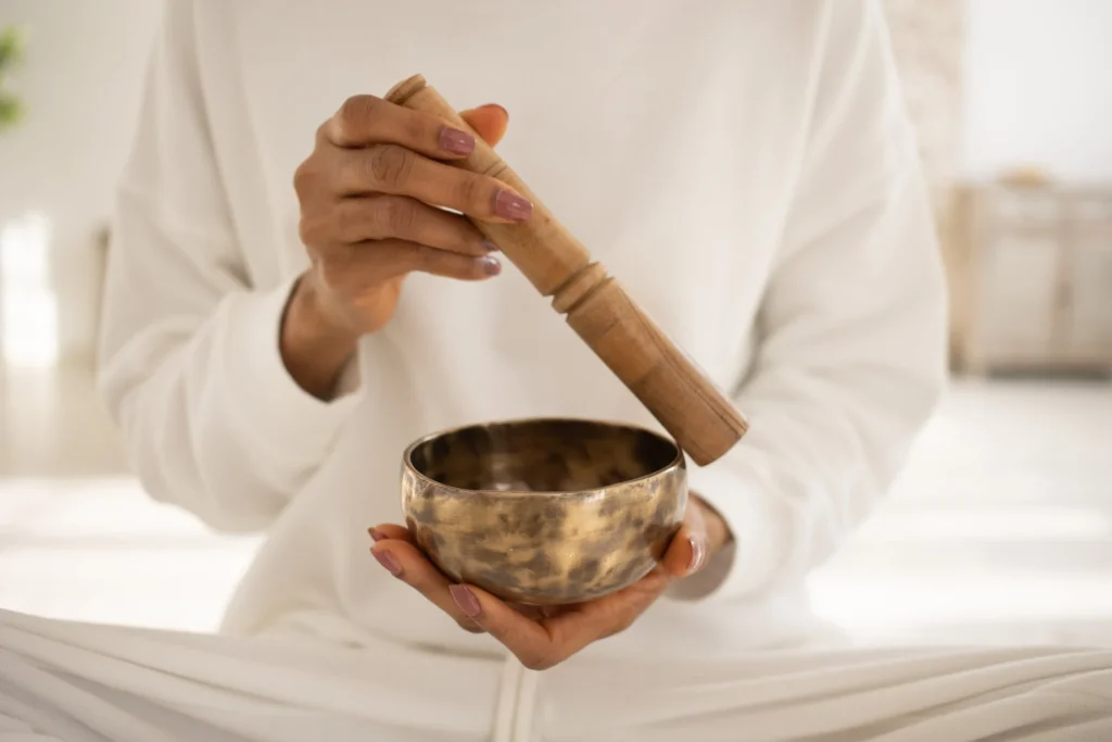 A person do the singing bowl Therapy